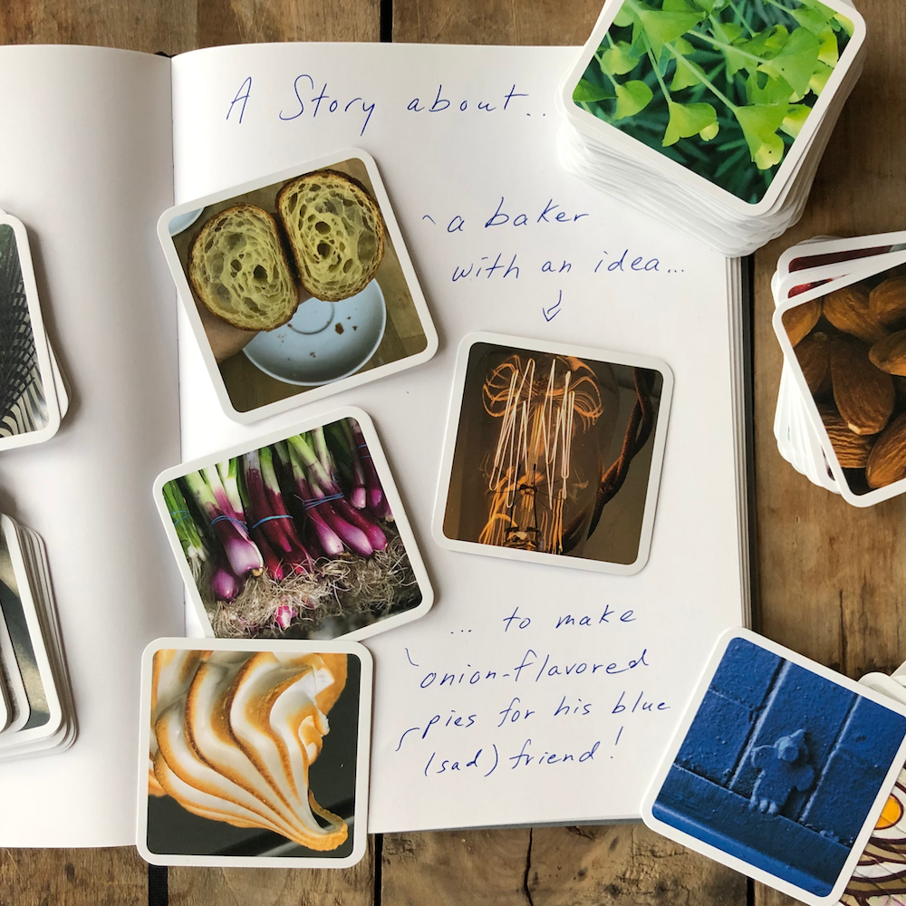 A writing book open with photo cards on top